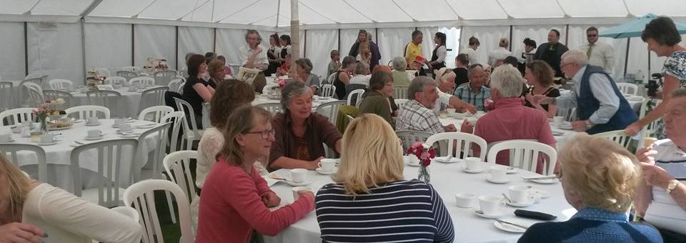 Photo of people have tea in a marquee.