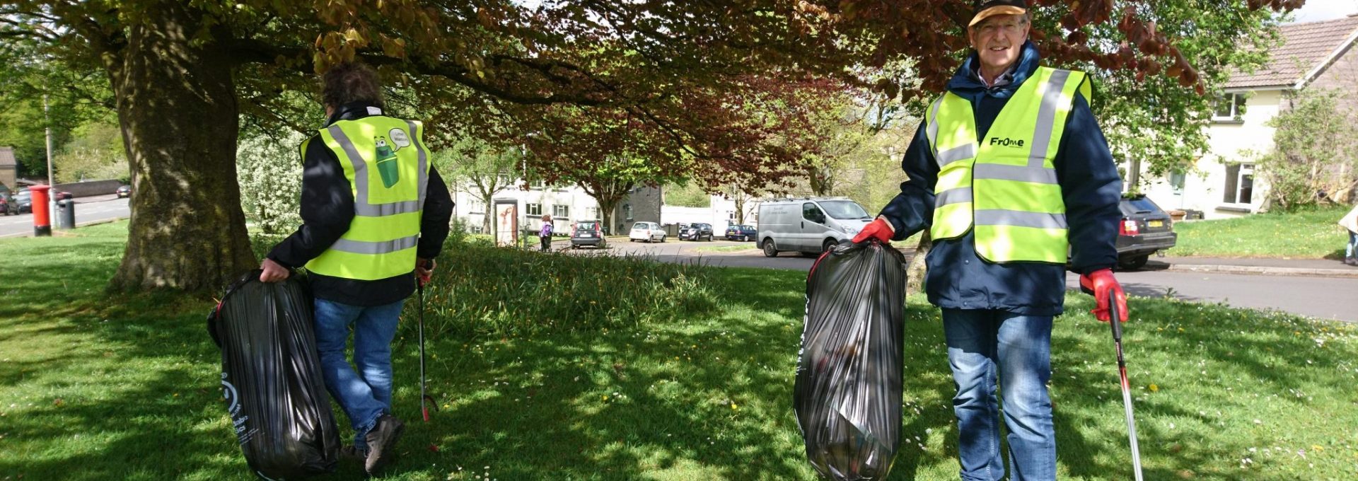 Man carrying bin bag and litter picker
